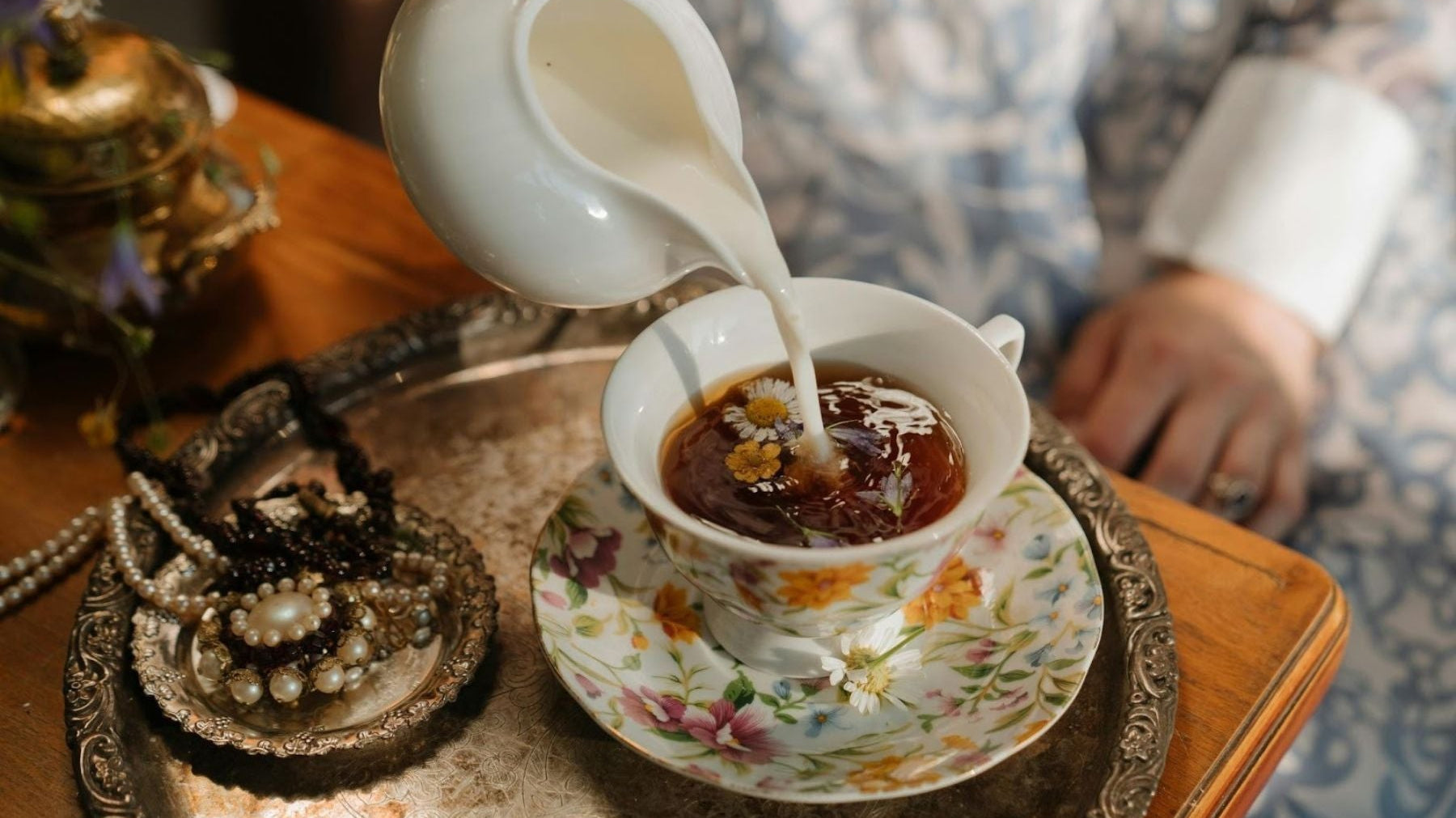 Milk being poured into black tea