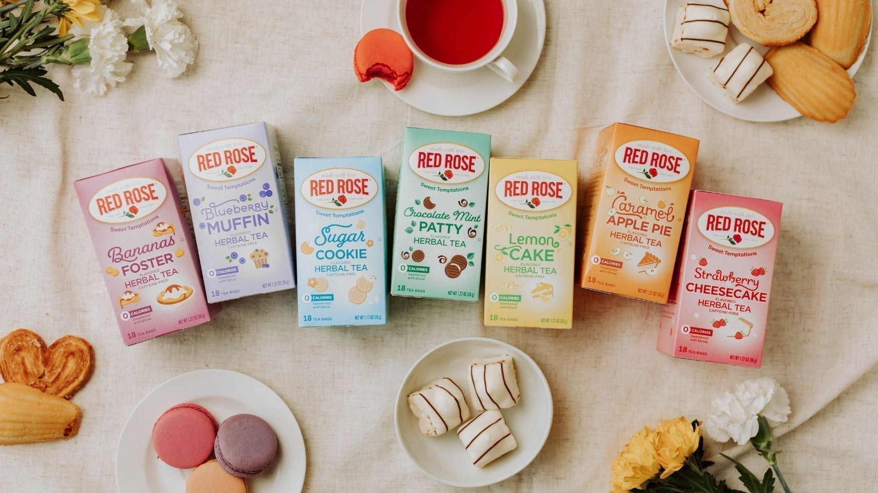 Red Rose dessert tea collection with pastries, macarons, and tea cups