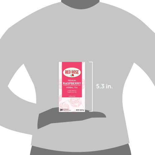 Red Rose Raspberry Herbal Tea package held by a hand on a gray background