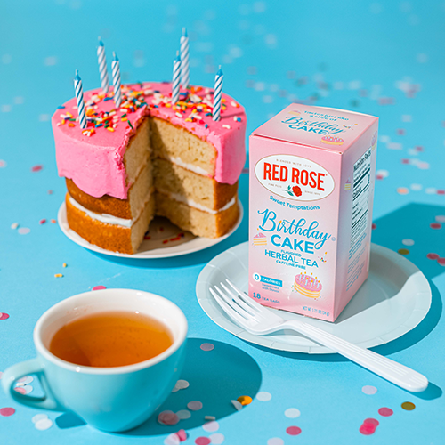 Red Rose Sweet Temptations: Birthday Cake next to a cake and a cup of tea