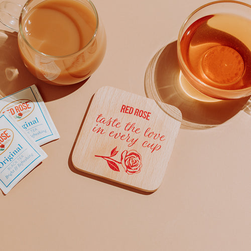 Red Rose "taste the love in every cup" coaster with cups of tea