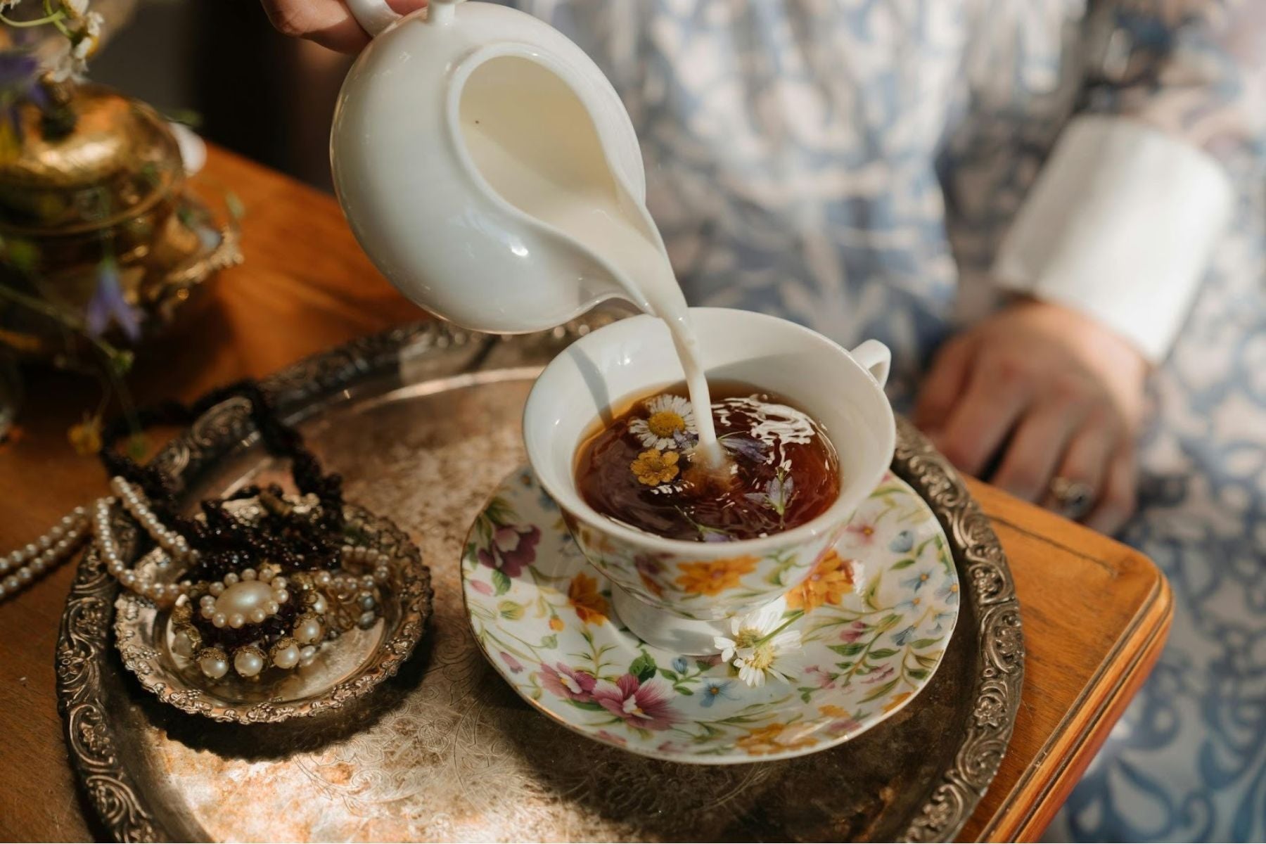 Milk being poured into black tea