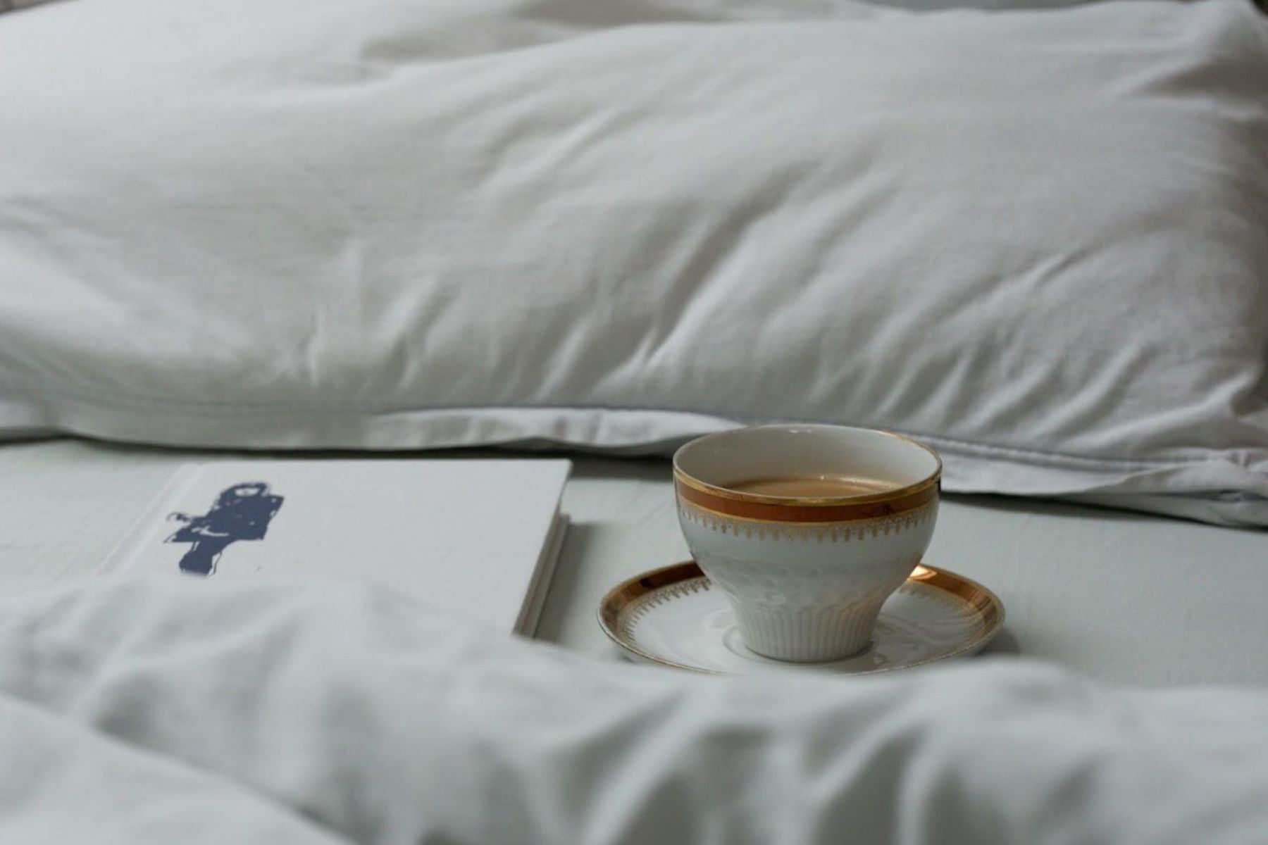A cup of Tea on a bed