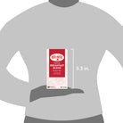 Red Rose tea package held by a hand on a gray background