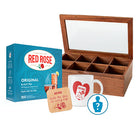 Red Rose Original Black Tea packaging with a wooden tea chest, mug, and coaster on a white background