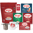 A tea gift set featuring Red Rose tea products including a large English Breakfast Loose Leaf Black Tea bag, a Bold Black Tea box, Irish Breakfast boxes, and smaller English Breakfast boxes, alongside a white mug with a Red Rose heart graphic and a metal tea infuser on a white background.